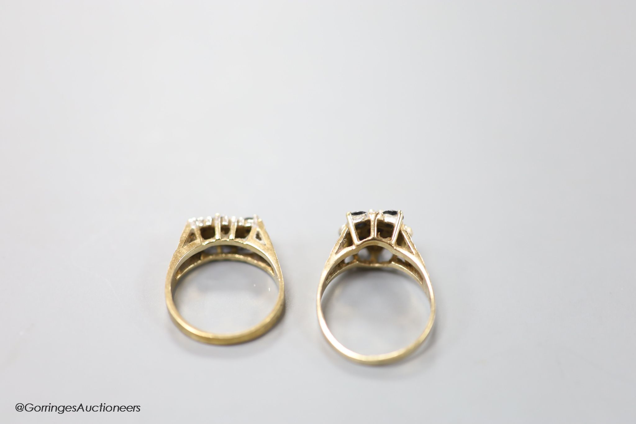 Two modern 9ct gold, sapphire and diamond chip set cluster rings